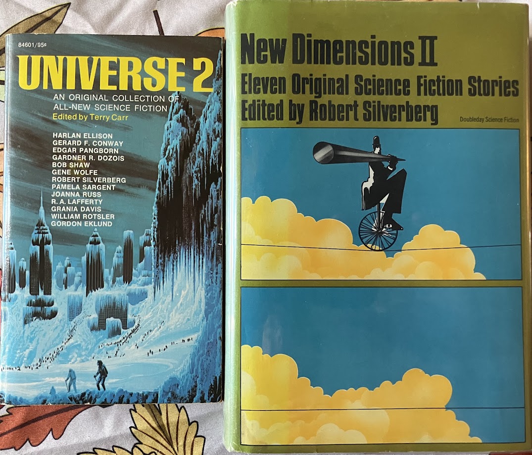 a photo of a paperback copy of Universe 2 next to a hardcover of New Dimensions II
